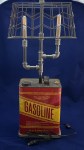 Gasoline can lamp with two bulbs and wire basket shade.